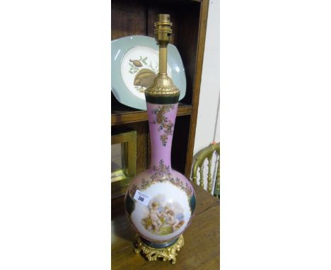 A Pink Porcelain and Gilt Metal Table Lamp of bulbous form, decorated with three putti to the front and standing on a polishe