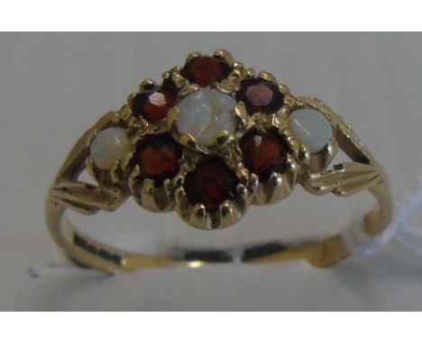 A Nine Carat Opal and Garnet Cluster Ring. Size O 1/2.