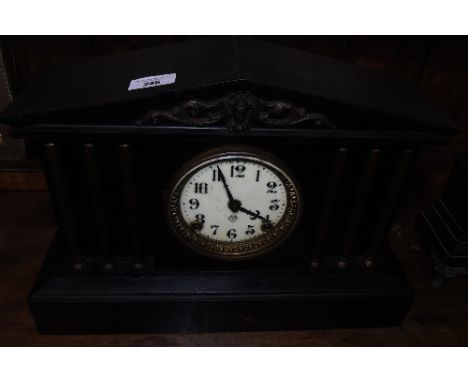 A Late 19th Century American Clock Garniture, of architectural design in black finish by the Ansonia Clock Company,