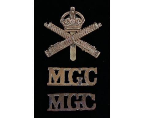 First World War cap badge to the Machine Gun Corps, slider to the reverse, K&amp;K 1154, together with two shoulder titles to