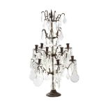 A CUT GLASS AND PATINATED METAL TWELVE LIGHT-CANDELABRA, IN THE MANNER OF MAISON JANSEN