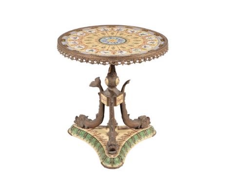 A FRENCH PORCELAIN, POTTERY, AND GILT METAL MOUNTED GUERIDON TABLE IN EMPIRE STYLE19TH CENTURYWith dolphin pattern supports64