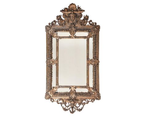 A DUTCH GILT COMPOSITION WALL MIRROR19TH CENTURY With marginal plates beneath mask and floral surmount180cm high, 88cm wide  