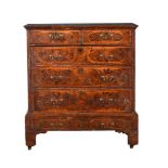 A WALNUT AND INLAID CHEST OF DRAWERS