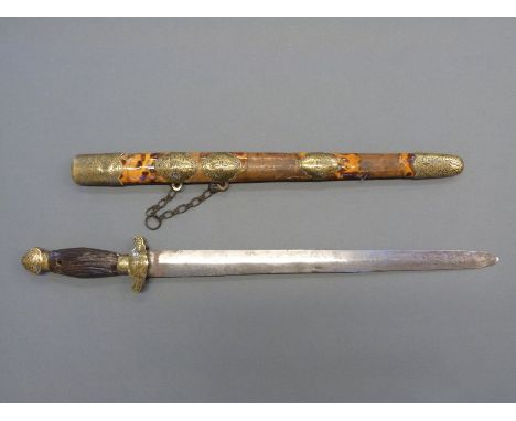 A 19thC Chinese brass mounted short sword with striated horn handle, in brass mounted tortoiseshell scabbard, blade length 41