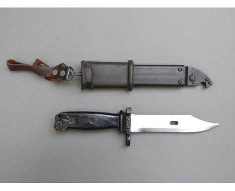 A 20thC Egyptian bayonet, scabbard and frog, the blade with serrated edge and wire cutting feature, blade length 15cm