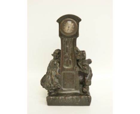 A late 19thC bronze clock in the form of a longcase clock with two Dutch children, the silvered dial with Roman numerals, sig