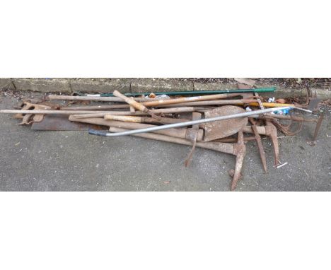 A collection of garden and other tools including saw, pickaxe etc 
