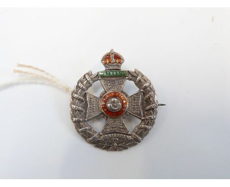 A silver badge marked sterling, reading 'Waterloo' in a green enamel tablet, the central Maltese cross bearing red circlet in