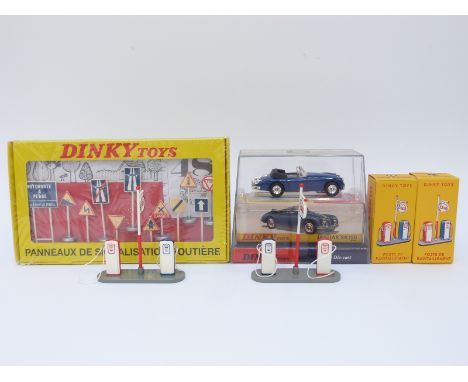 Four Atlas Editions Dinky Toys diecast model vehicles and accessories comprising Two Esso Petrol Pump Sets 49D, set of 12 Fre