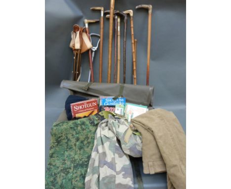 A collection of horn mounted sticks, spade, shooting seats, books on shooting, stick making and wildlife in a green Cobham ho