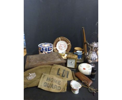 A carved wooden box, jewelled Coalport plate, Royal Doulton, brass carriage clock, military hat with badge, plated ware, Mint