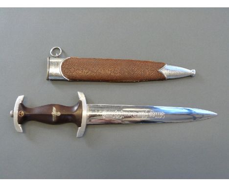 A Nazi German SA dagger marked RZM M7/49 to the 22cm blade in covered metal scabbard