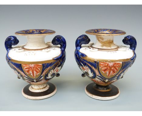 A pair of Regency porcelain inkwells and potpourri, in the form of urns with beast finials, with Imari and gilt decoration, p