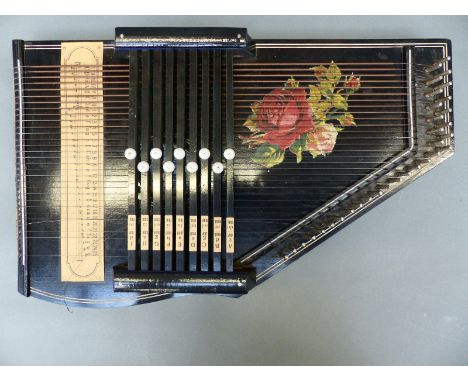 German auto harp with nine chord options and lacquered black finish with rose design