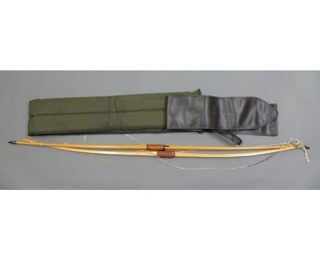 Two wooden laminated longbows, one with leather grip and two bow and arrow slips