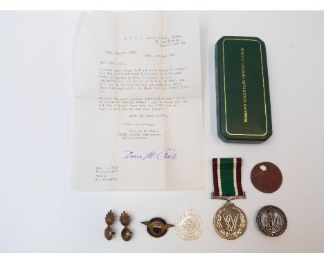 A cased Women's Voluntary Service medal, badges including carved mother-of-pearl Royal Engineers sweetheart token, WWI dog ta