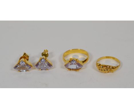 A pair of purple stone set stud earrings and matching ring, finger size O; and a further 18 carat gold ring, finger size M.  