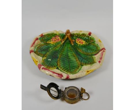 A late 19/early 20th century continental majolica pottery leaf dish together with a military issue brass cased compass (2)