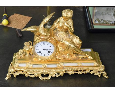 A gilt metal figural mantel clock, of a seated maiden