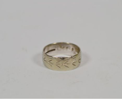 An 18 carat white gold engraved band ring, finger size S. Gross weight 6.0 grams.