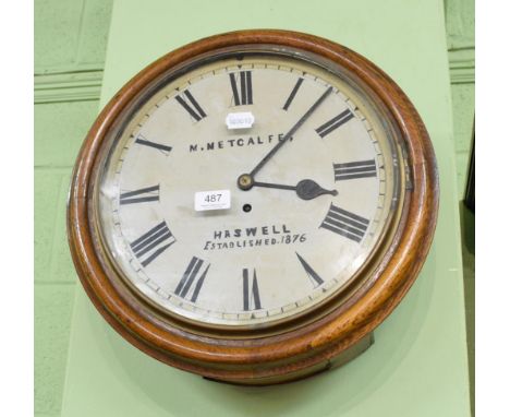 Oak framed circular wall clock, bearing the name 'M Metcalfe, Haswell' with key