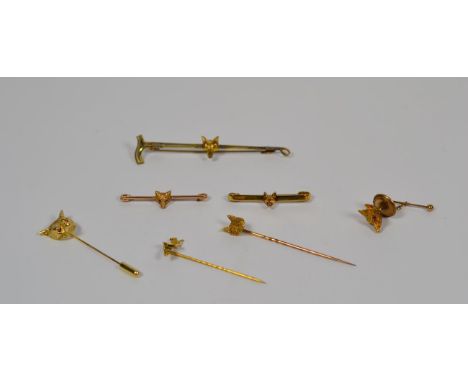 Three fox head stick pins; three fox head bar brooches; and a 9 carat gold fox head tie stud.  Three stick pins - 6.79 grams.