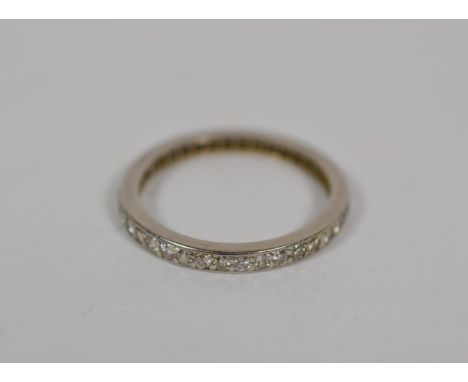 A diamond eternity ring, finger size L.  Slightly out of shape. No marks. Gross weight 2.4 grams