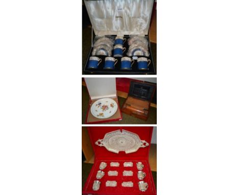 A 20th century Middle Eastern white metal filigree and porcelain coffee set, comprising six cups in holders and saucers, with