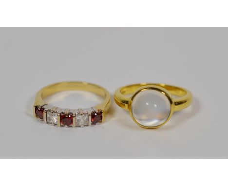 An 18 carat gold moonstone ring, finger size L1/2; and a red and white five stone ring, finger size L1/2 (2).  Moonstone ring