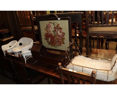 Dolls four piece Lloyd Loom furniture set; a crib; a metal framed bed; together with two footstools; and an embroidered fire 