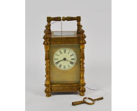 A late 19th/early 20th century brass carriage clock, white enamel Roman dial within gilt face, 8 day striking movement, elabo