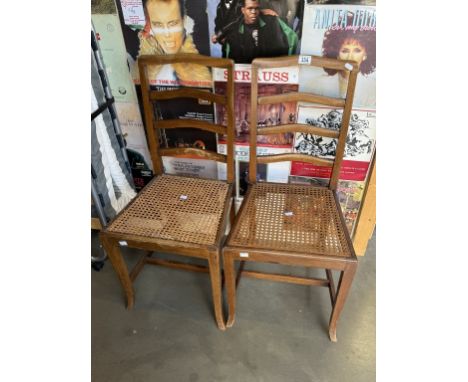 A pair of Edwardian ladder back chairs with bergÃ¨re seats