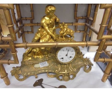 A gilded mantel clock featuring a goat herd and goat, in working order. 