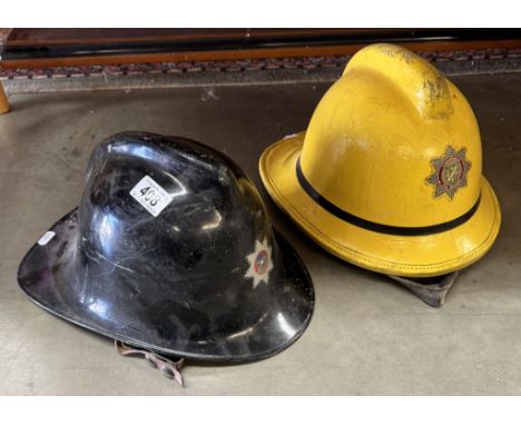 Two vintage fireman helmets. One Lincolnshire Fire Brigade