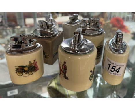 Vintage Ronson trophy table lighter depicting a stage coach and other transport related lighters
