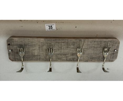 A designer architectural coat rack made from reclaimed materials