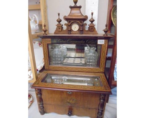 A magnificent Victorian marquetry inlaid music box incorporating a tantalus with two decanters, in working order. 