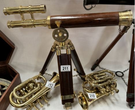 A brass telescope on hardwood tripod base