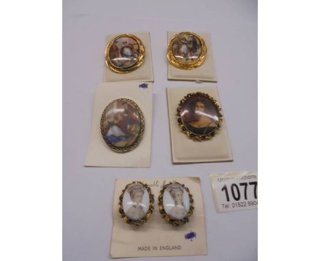 Four vintage picture brooches and a pair of earrings. 