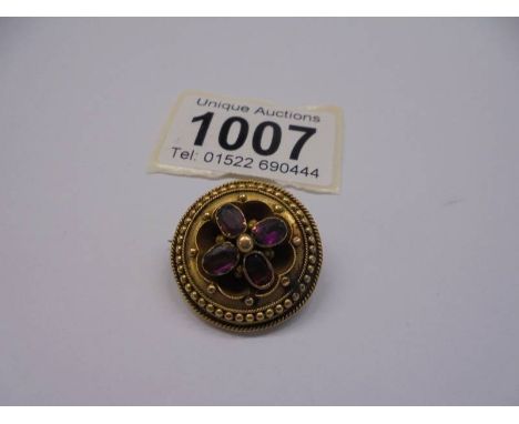 A Victorian yellow metal brooch set amethyst?