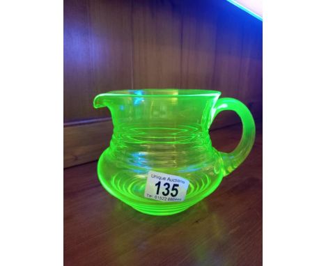An art deco green uranium glass jug