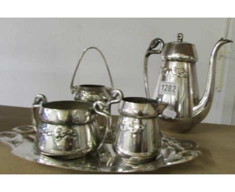 A four piece silver plated coffee set with swan handles and one other item. 