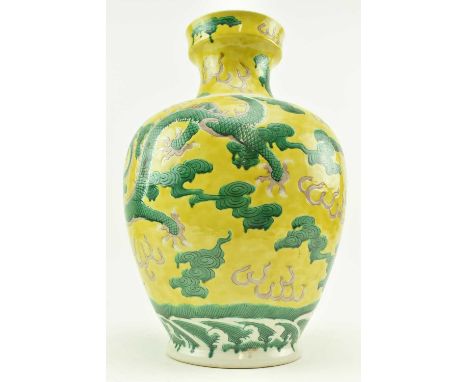 A 20th century Chinese ceramic yellow ground Dragons vase. The baluster shaped vase decorated with incised two dragon five-cl