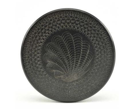An early 20th century circular gutta percha carved snuff box. The snuff box decorated with spirograph drawing of flowers and 