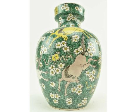 A 20th century Chinese ceramic famiile vert vase. The baluster shaped vase decorated green ground wth black spirals, horses, 