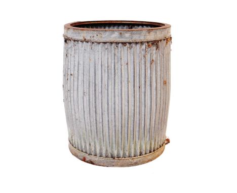 A vintage corrugated galvanised steel planter. Circular form, with ribbed sides.Measures approx. 44cm tall.