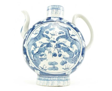 A 20th century blue and white ceramic ewer. The moon flask shaped ewer pot with spout decorated with two dragons amidst cloud