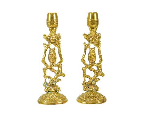 A pair of late 19th / early 20th century owl themed candlestick holders. Brass construction, with central owl design and acor