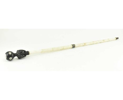 An early 20th century Japanese engraved and carved bone walking stick. The cane featuring wooden pommel decorated with bone i